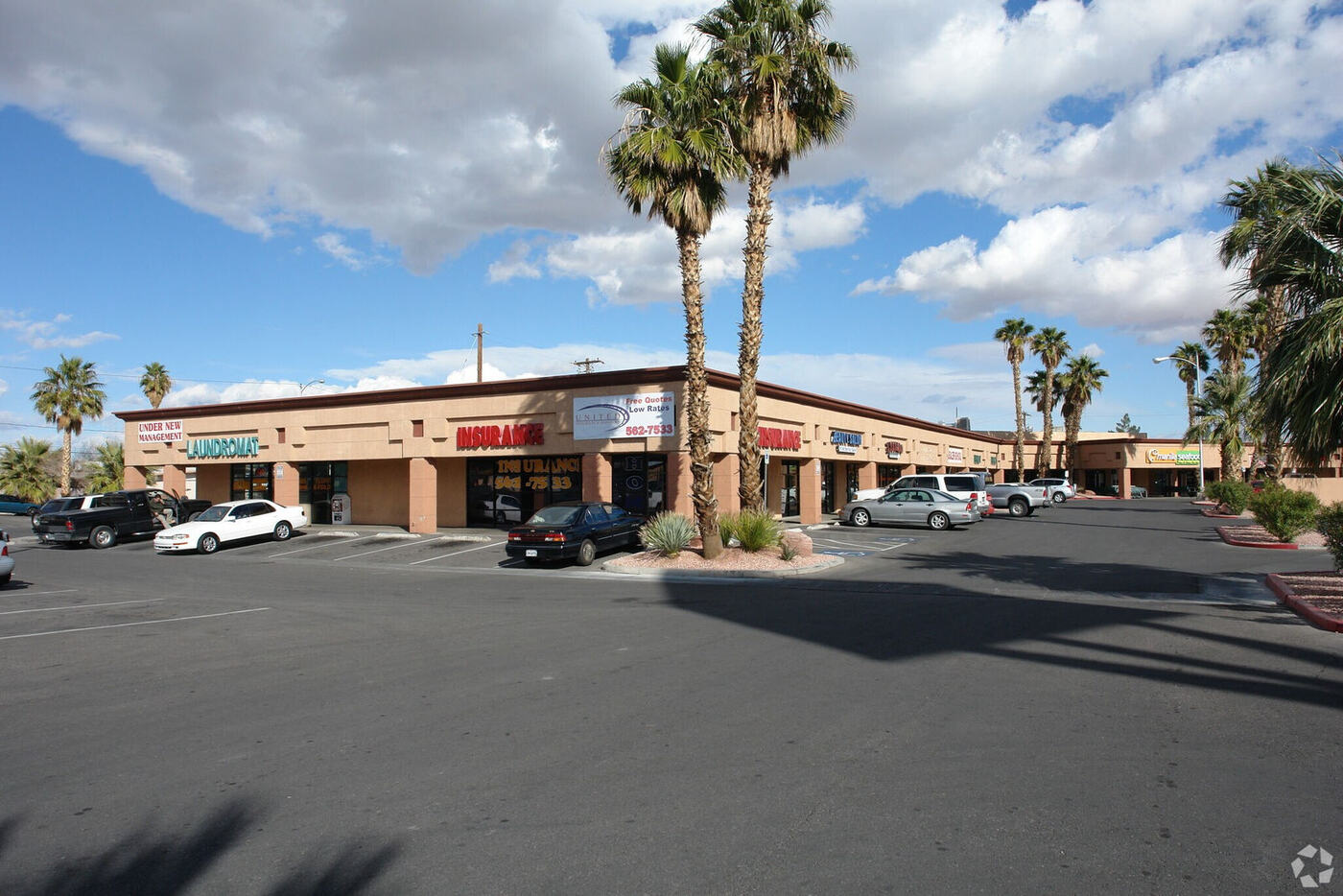 Amall Shopping Center storefronts and parking lot with palm trees on E Sahara Ave